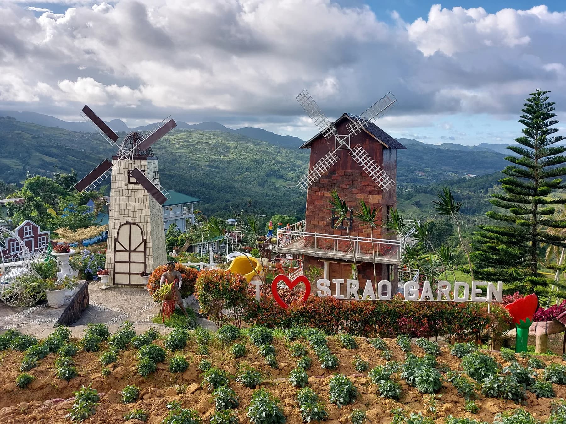 Decorative windmills and planted terraces at the Original Sirao Garden